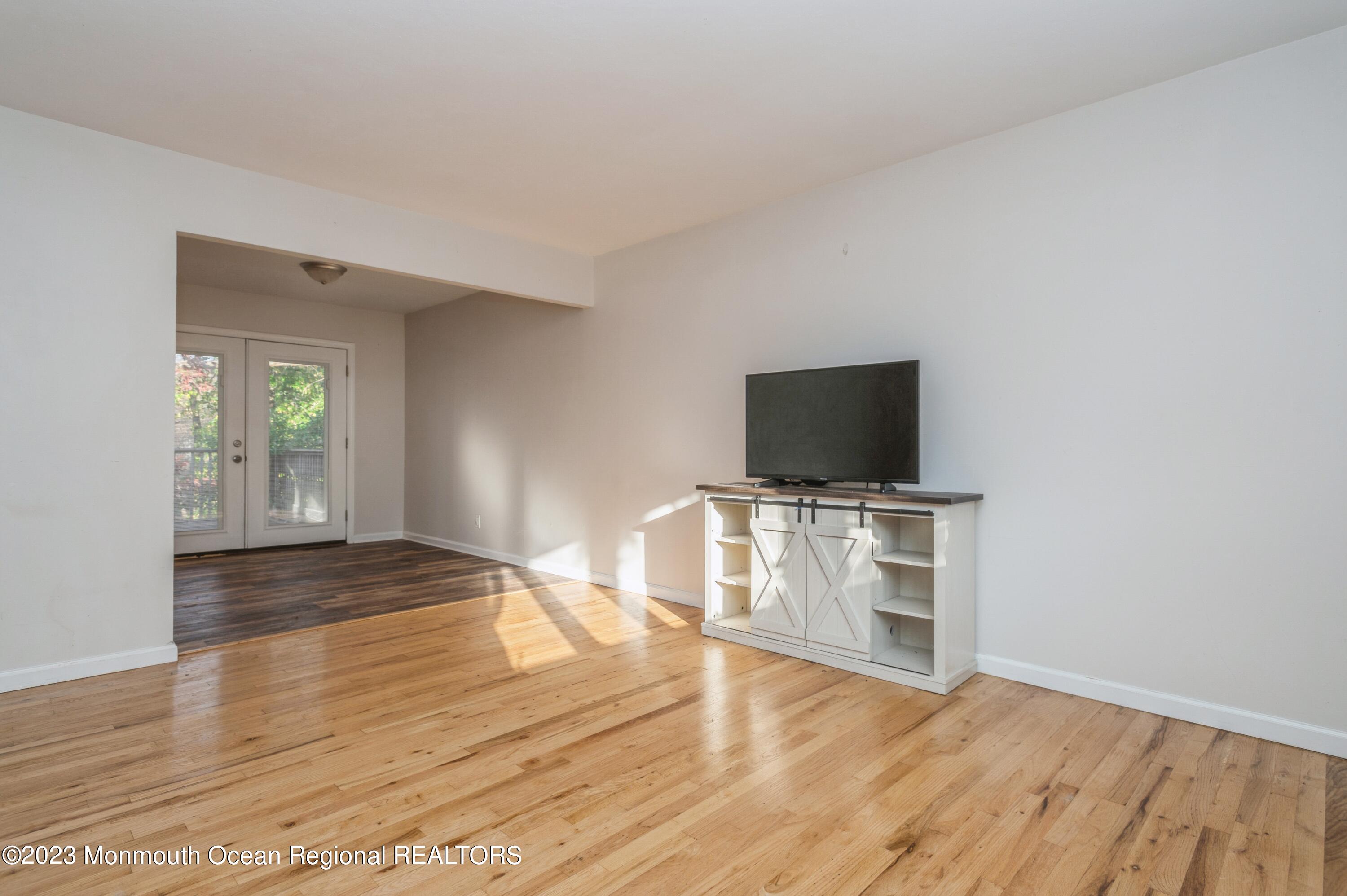 121 Darien Road Howell, NJ 07731 - Photo 9 of 19 a view of a livingroom with wooden floor and a flat screen tv