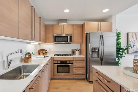 a kitchen with a sink stove and refrigerator