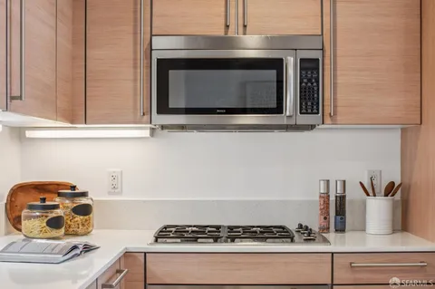 a stove top oven sitting inside of a kitchen