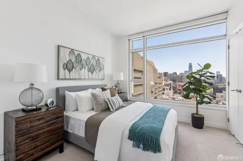 a bedroom with bed and a potted plant