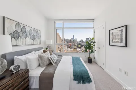 a spacious bedroom with a bed and a large mirror