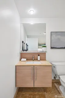 a bathroom with a sink toilet and mirror