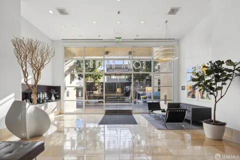 a lobby with furniture and a potted plant