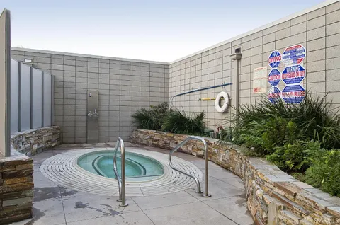 a building outdoor space with patio furniture and potted plants