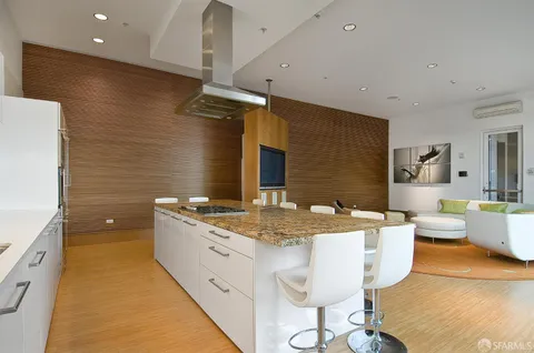 a spacious bathroom with a granite countertop sink a mirror and a bathtub