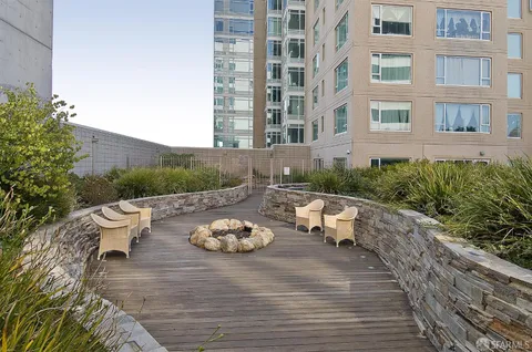 a view of a patio with couches and table potted plants