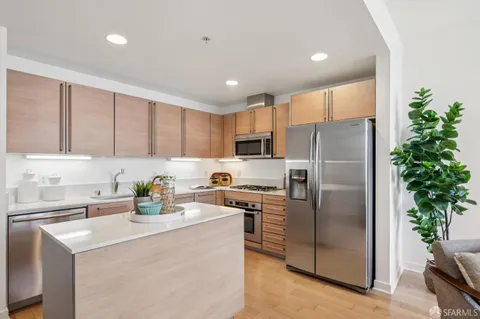 a kitchen with stainless steel appliances a refrigerator sink and cabinets