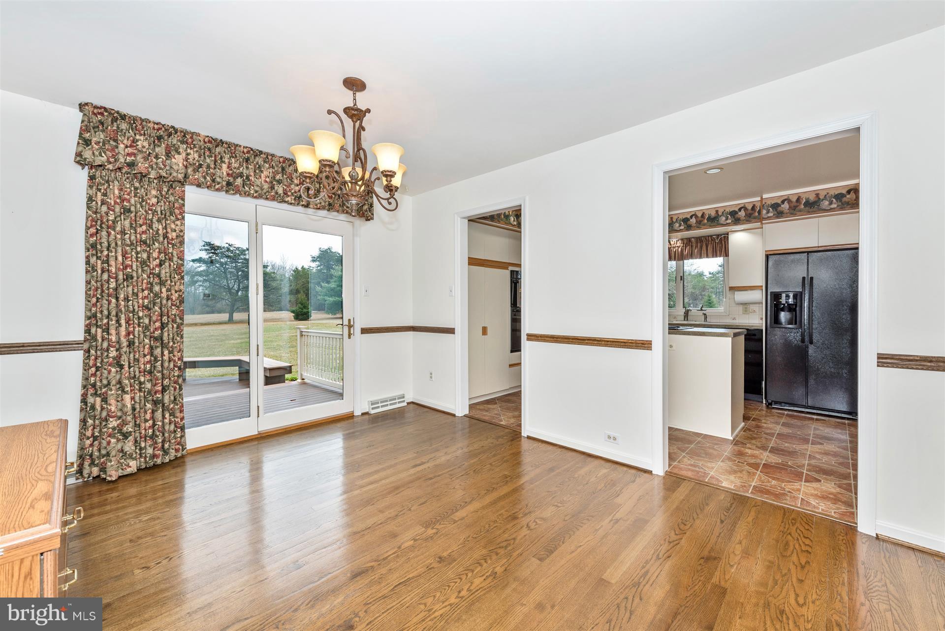 10823 Shanktown Road Big Pool, MD 21711 - Photo 14 of 30 a view of a hallway view with wooden floor and a kitchen