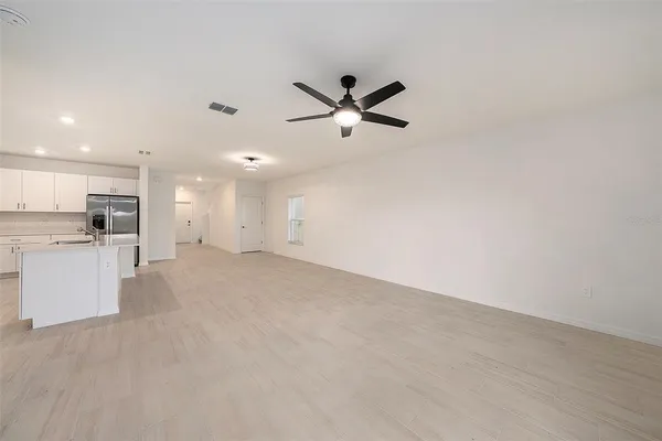 a view of a kitchen with a sink and cabinets