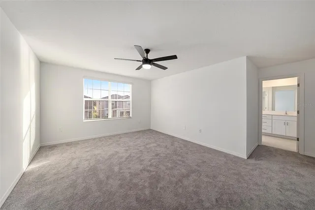 a view of a livingroom with a ceiling fan and window
