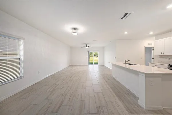 a view of a kitchen with wooden floor and windows