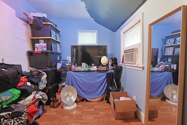 a bedroom with furniture and a wooden floor