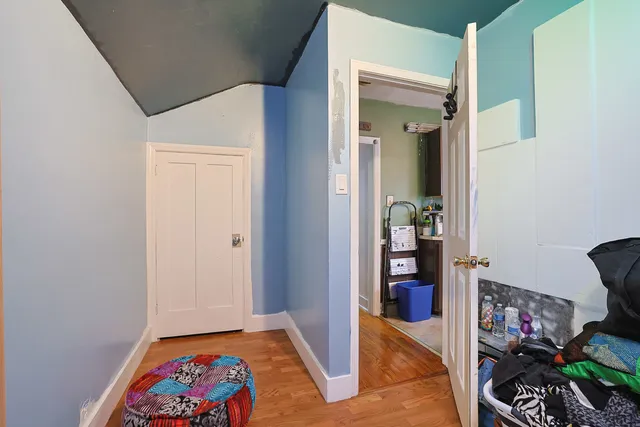 a kitchen with stainless steel appliances a sink cabinets and wooden floor