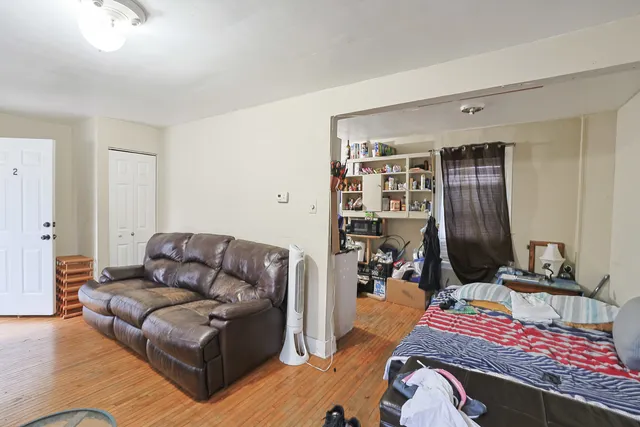a living room with furniture and a mirror