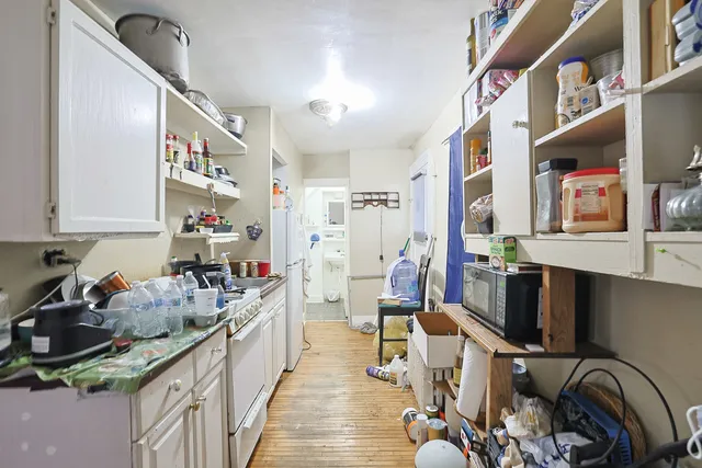 a living room with furniture a flat screen tv and a window