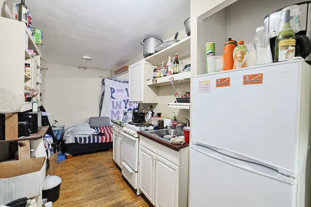 a living room with furniture a flat screen tv and a large window