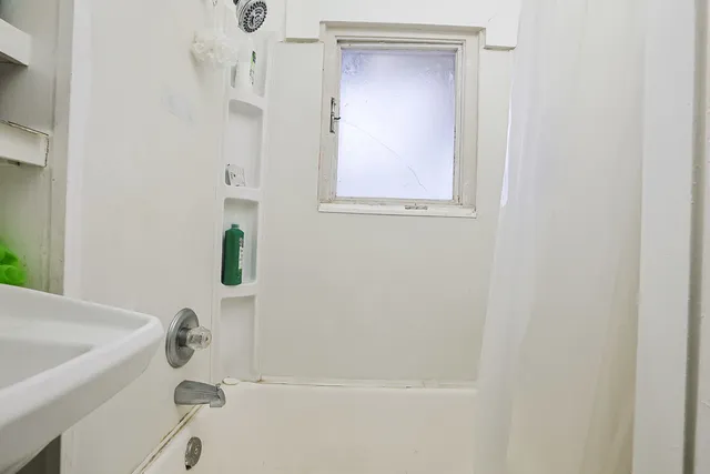 a kitchen with stove a sink and cabinets