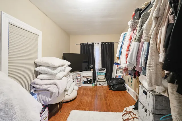 a view of a living room with furniture and wooden floor