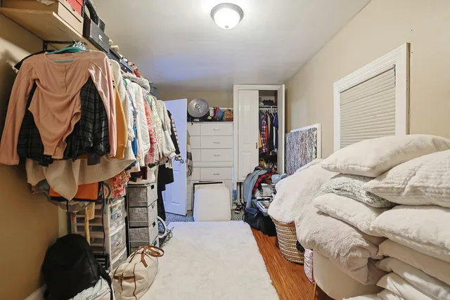 a bedroom with a bed and walk in closet