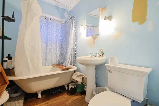 a bathroom with a sink toilet and a mirror