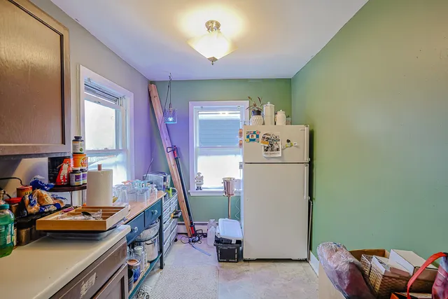 a living room with furniture kitchen and a window