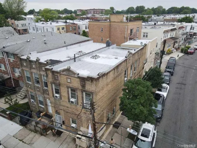 an aerial view of a house with a yard and balcony