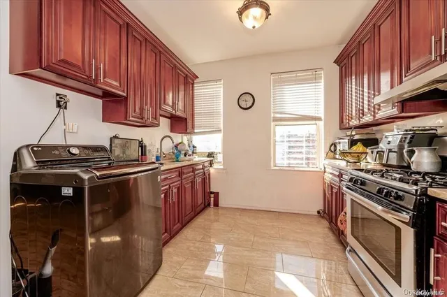 a kitchen with a stove top oven sink and cabinets