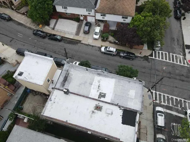 an aerial view of residential house with parking
