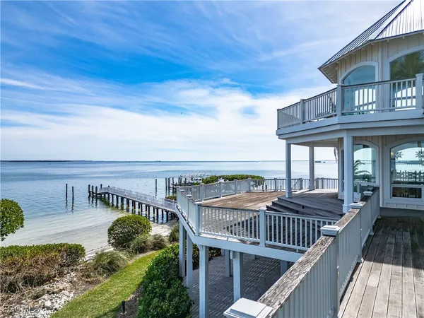 a view of a roof deck with couches and wooden floor