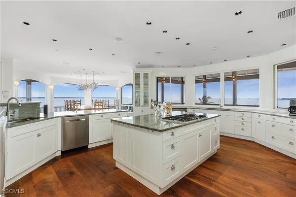 a kitchen with granite countertop a sink and cabinets