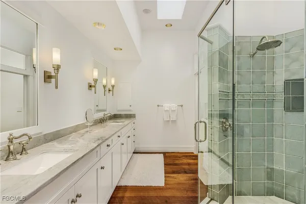 a spacious bathroom with a granite countertop sink a toilet and shower