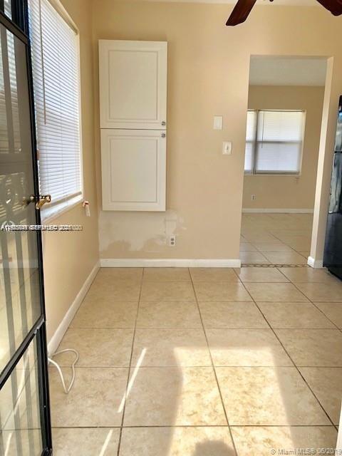 1064 Southwest 2nd Street, Unit 1 Hallandale Beach, FL 33009 - Photo 6 of 14 an empty room with a mirror