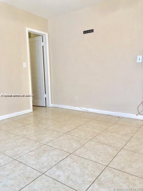 1064 Southwest 2nd Street, Unit 1 Hallandale Beach, FL 33009 - Photo 10 of 14 an empty room with a natural light