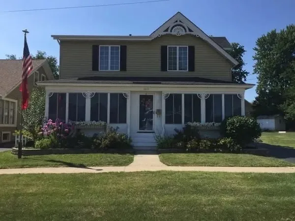 a front view of house and yard with green space