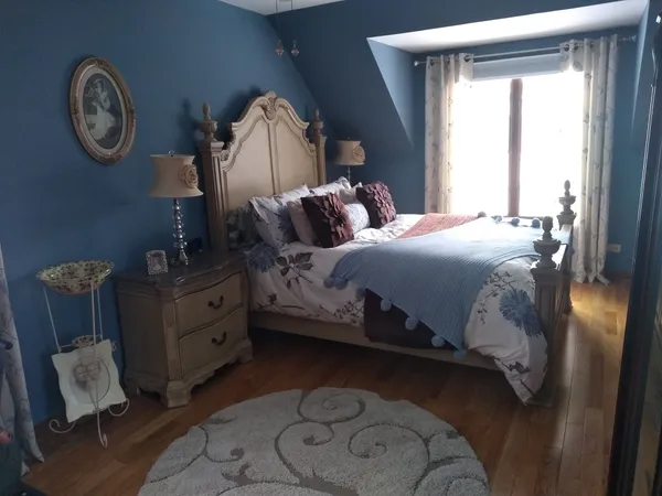 a bedroom with a bed and a chandelier