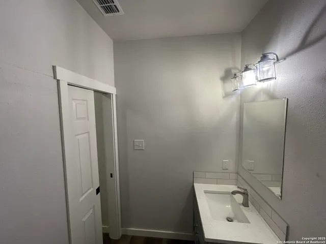 a bathroom with a toilet a sink and shower