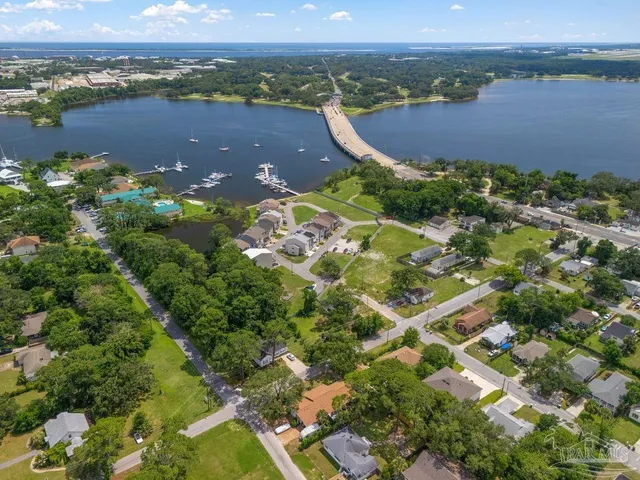 an aerial view of residential houses with outdoor space and river