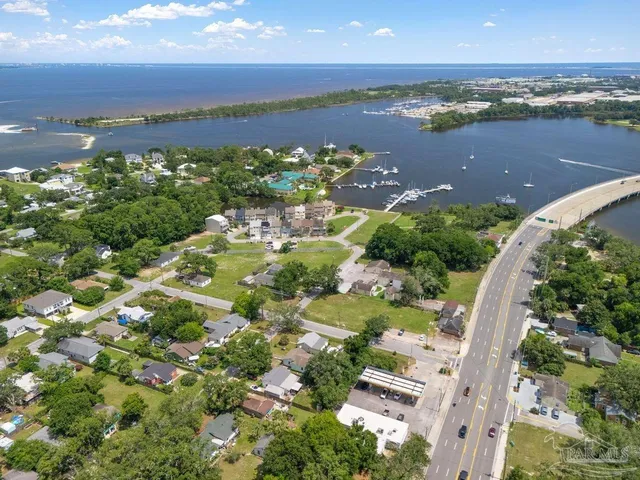 an aerial view of ocean and residential houses with outdoor space and ocean view