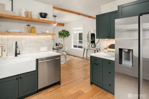 a kitchen with stainless steel appliances a sink dishwasher stove refrigerator and microwave
