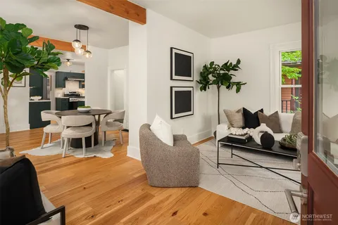 a living room with furniture potted plant and a window