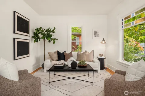 a living room with furniture a flat screen tv and a window
