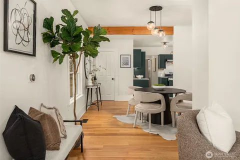 a dining room with furniture and wooden floor
