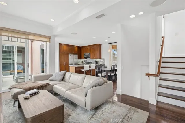 a kitchen with granite countertop a stove a sink and a refrigerator