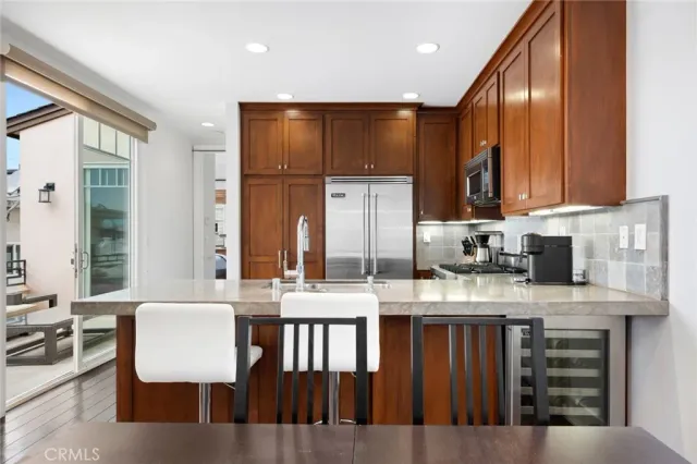 a kitchen with refrigerator cabinets and wooden floor