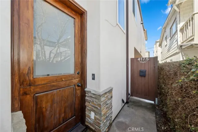 a view of staircase with wooden floor and white walls