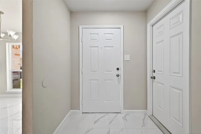 a view of a kitchen with microwave and windows