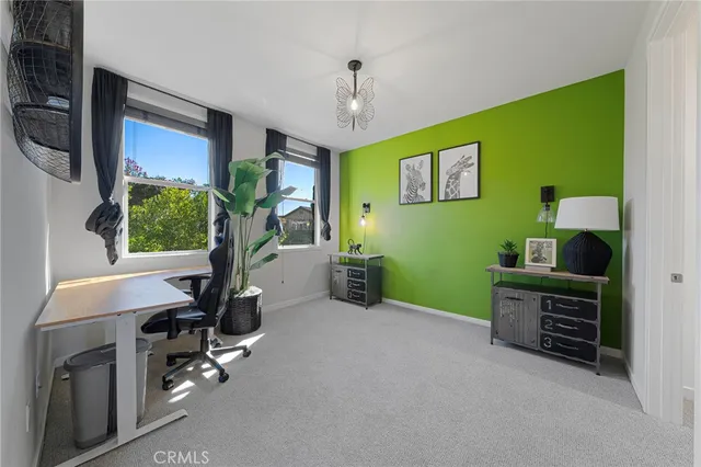 a bedroom with a bed and a potted plant