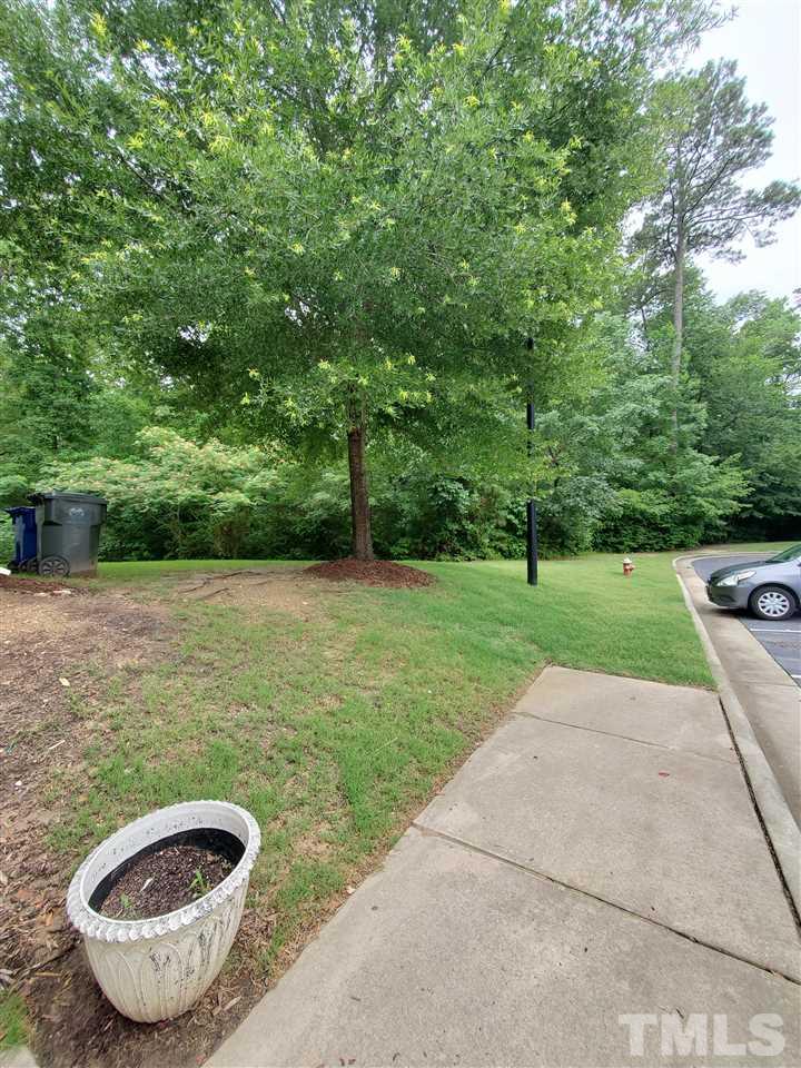 8208 Clasara Circle Raleigh, NC 27613 - Photo 2 of 26 a view of a swimming pool with a yard