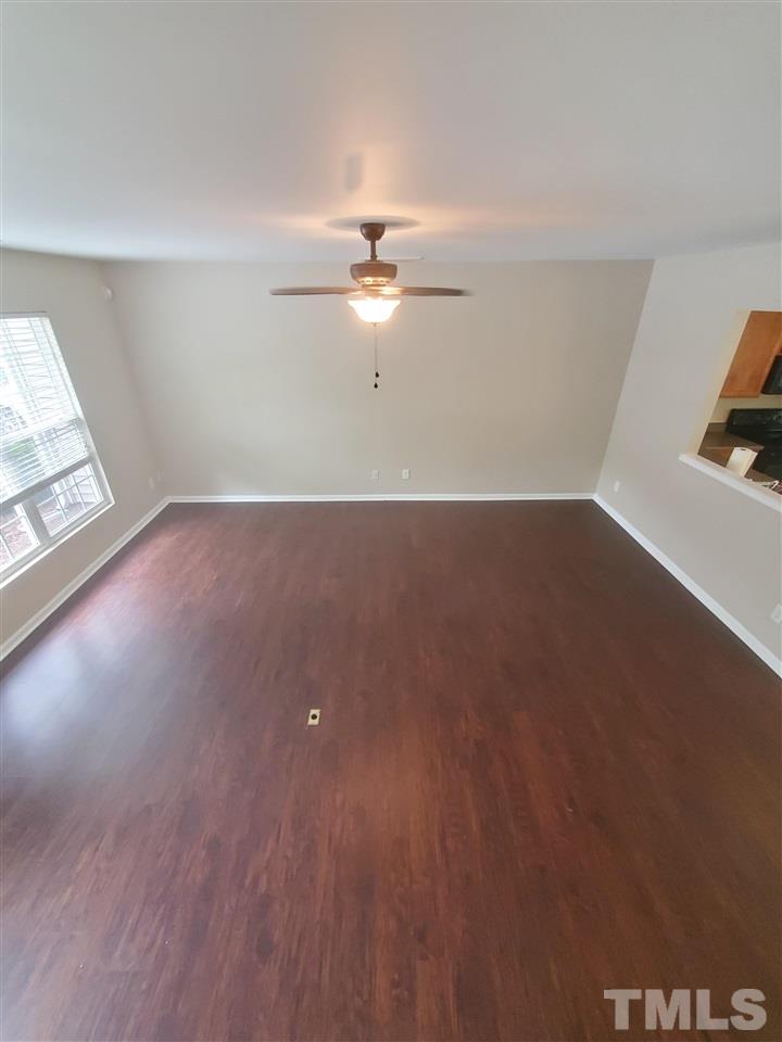 8208 Clasara Circle Raleigh, NC 27613 - Photo 4 of 26 wooden floor in an empty room with a window