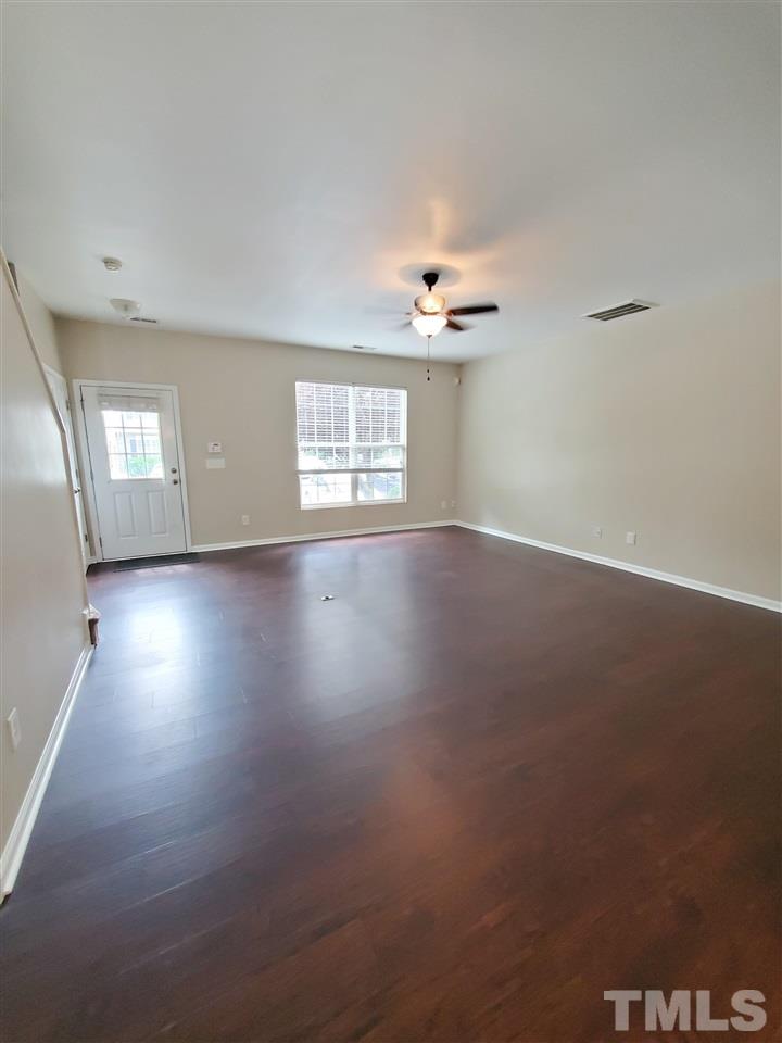 8208 Clasara Circle Raleigh, NC 27613 - Photo 5 of 26 an empty room with wooden floor and windows